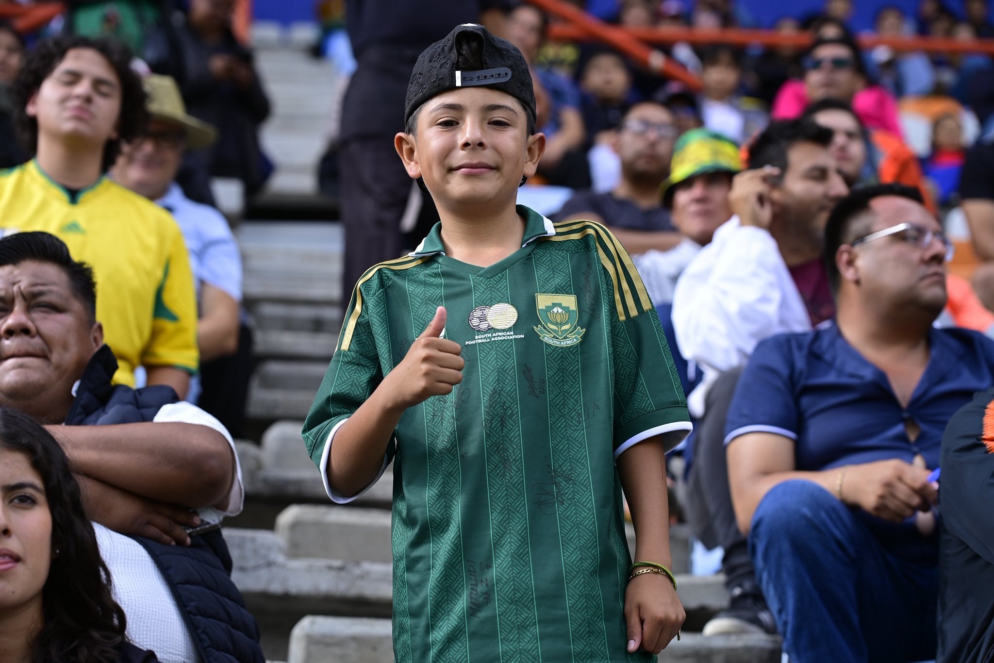 he young Mexican boy - Luchito, who met the Bafana Bafana players outside the team's hotel in Pachuca, Mexico, was later gifted with an alternate green jersey by head coach Hugo Broos before the entire 26-man squad lined up to sign his shirt and World Cup album